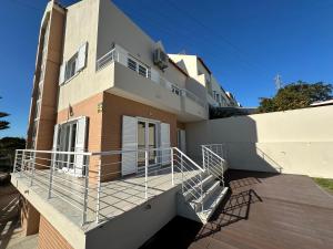 a house with a balcony and stairs on it at Solar da Sobreda in Sobreda