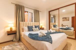 a bedroom with a large bed with a large mirror at Stero House by Atlantic Holiday in Caniçal
