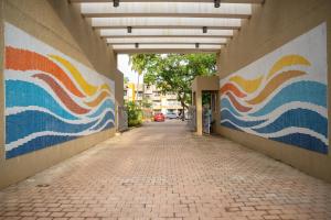 a hallway with colorful murals on the side of a building at Casa Leo by Leo Homes 2BHK Flat near Anjuna Beach in Anjuna