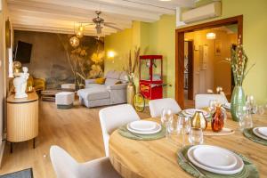 a dining room with a table and chairs and a living room at LES GRANGES DE JADIS ALSACE Bis in Holtzwihr