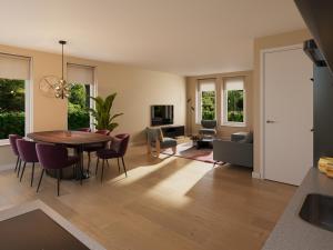 a kitchen and living room with a table and chairs at Dormio Water Resort Medemblik in Opperdoes