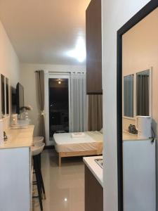 a hotel room with a bed and a bathroom at Cozy Studio with Balcony and Pool Near Airport and Beaches in Suba