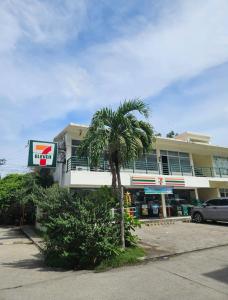 a palm tree in front of a building at Cozy Studio with Balcony and Pool Near Airport and Beaches in Suba +19 photos