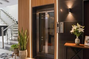 a hallway with a glass door with plants on it at FabHotel Jalsa DLX in Bhopal