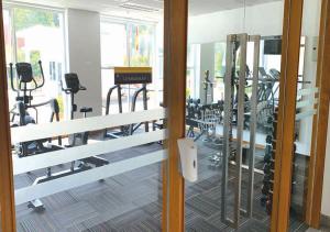 a gym with treadmills and machines in a room at Cozy Hotel Primera Suite Cyberjaya in Cyberjaya