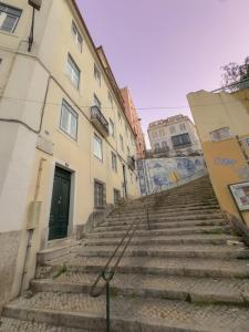 a set of stairs in a city with buildings at Descubra Lisboa - Príncipe Real in Lisbon