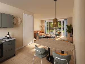 a kitchen and living room with a table and chairs at Dormio Water Resort Medemblik in Opperdoes