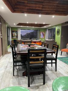 a dining room with a table and chairs at Santuyoc in Volcán