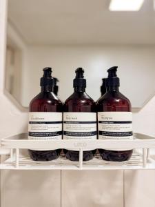 four bottles of wine sitting on a shelf in a refrigerator at Gangdong Station 10-minute walk Cozy Sweet Stay in Seoul