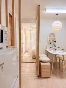 a kitchen with a table and a dining room at Gangdong Station 10-minute walk Cozy Sweet Stay in Seoul