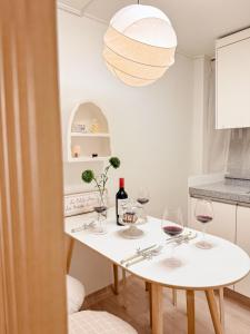 a table with wine glasses and a pendant light at Gangdong Station 10-minute walk Cozy Sweet Stay in Seoul +32 photos