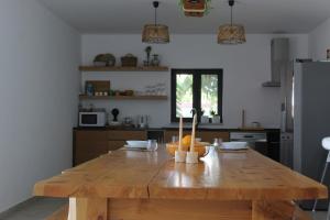 a kitchen with a wooden table with fruit on it at Casa do Caseiro, São Silvestre in São Silvestre