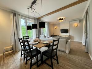 une salle à manger et un salon avec une table et des chaises dans l'établissement Alpennelke family apartments, à Bohinjska Bela