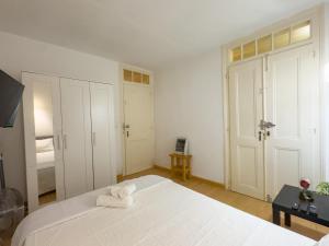 a bedroom with a large white bed with towels on it at Descubra Lisboa - Príncipe Real in Lisbon
