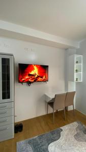 a living room with a fire on the wall at Honey's Staycation in Davao City