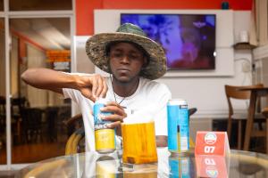 a man wearing a hat sitting at a table at Hotel Windsor-Mombasa in Mombasa