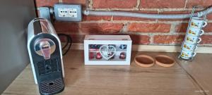 a toaster sitting on a wooden table next to a box at Poseidone in Trofarello
