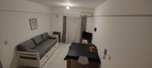 a living room with a couch and a table at Depto Velez Sarsfield in Cipolletti