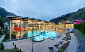 a large building with a pool in front of it at Casa Moselle-Royal Stilvoll Urlauben an der Mosel in Reil