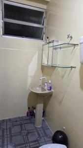 a bathroom with a sink and a mirror at Loft Hipolito in Belém +10 photos