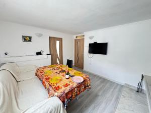 a room with a bed and a table with food on it at Lipite Guest House in Yantra