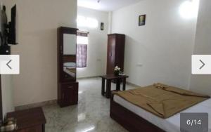 a bedroom with a bed and a mirror and a table at New GM Comforts in Bengaluru