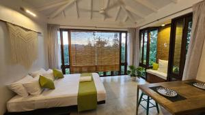 a bedroom with a bed and a large window at Casa Selvita in Kandy