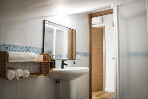 a bathroom with a sink and a mirror at Suites Puerta Doñana in Hinojos