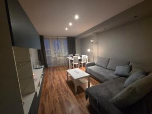 a living room with a couch and a table at Apartament KARO in Zawiercie