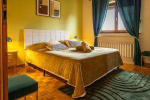 a bedroom with a large bed with yellow walls and a window at LES GRANGES DE JADIS ALSACE Bis in Holtzwihr +82 photos