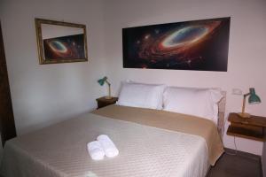 a bedroom with a bed with two white towels on it at Casa Vacanze Galileo in San Gregorio +68 photos