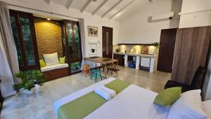 a living room with a bed and a kitchen at Casa Selvita in Kandy +23 photos