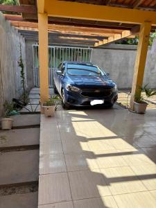 a car parked under a cover in a driveway at Casa Viturino in Tailandia