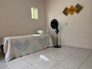 a room with a table and a fan on the wall at Casa Viturino in Tailandia
