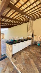 an outdoor kitchen with a counter and a fireplace at VIP eventos in Juazeiro do Norte +21 photos