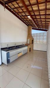 a kitchen with a sink and a stove in a room at VIP eventos in Juazeiro do Norte