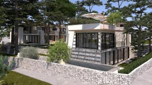 a house with a stone wall in front of it at VICE VERSA -Seaside boutique Villa with Pool in Punat