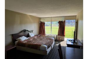 a hotel room with a bed and a window at Hotel O Star Motel Hattiesburg HWY 49 in Hattiesburg