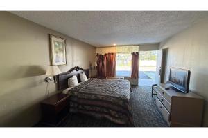 a hotel room with a bed and a television at Hotel O Star Motel Hattiesburg HWY 49 in Hattiesburg