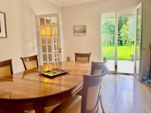 a dining room with a wooden table and chairs at Foxgloves in La Motte