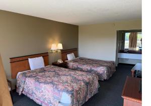 a hotel room with two beds and a window at Hotel O Star Motel Hattiesburg HWY 49 in Hattiesburg +11 photos