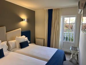 Postel nebo postele na pokoji v ubytování Hotel Boa Vista