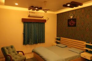 a bedroom with a bed and a chair in it at Zianas's Den in Bengaluru