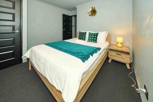 a bedroom with a large bed and a night stand at Quite and nature paradise in Byford