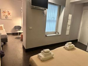 Ένα ή περισσότερα κρεβάτια σε δωμάτιο στο Holidays Rooms Rattazzi