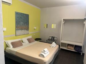 Ένα ή περισσότερα κρεβάτια σε δωμάτιο στο Holidays Rooms Rattazzi