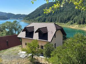 a house with a roof on top of a river at Apartman Brod in Konjska Reka