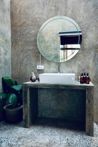 a bathroom with a sink and a mirror at Corabelle Gili Air in Gili Air