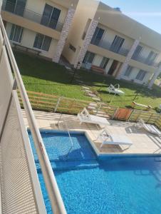 a swimming pool in front of a apartment building at Complejo Marlu in Federación +10 photos
