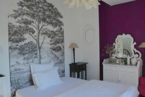 a bedroom with a white bed with a tree mural on the wall at la maison, chambre d'hôtes de charme et atelier d'artiste, Libourne saint Emilion in Libourne +95 photos